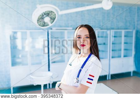 Medicine And Healthcare Concept. Female Doctor Surgeon Working At Surgery Room And Smiling At Camera