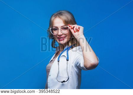 Portrait Of An Attractive Young Female Doctor In White Coat.