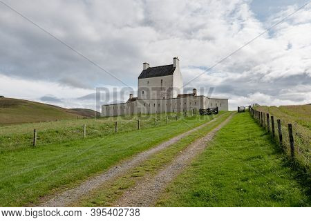 Landscape With White Corgarff Castle In Socttish Landscape At Nice Sunny Afternoon