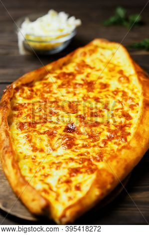 Turkish Flatbread (pide) With Cheese. Kasarli Pide On The Dark Wooden Table. Close Up. Traditional T