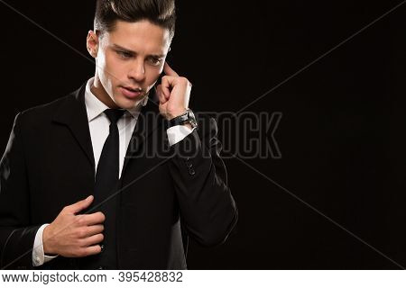 Handsome Professional Bodyaguard Listening To Instructions On His Earpiece On Black Background Copys