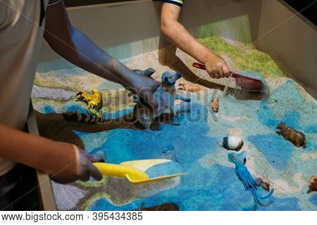 Kids Play With Augmented Reality Sandbox. Interactive Sandbox, Educational And Entertaining World Fo