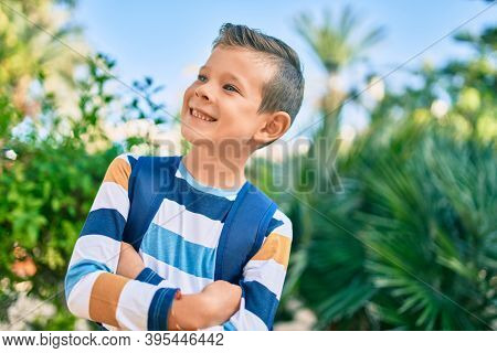 dorable caucasian student boy smiling happy standing at the park.