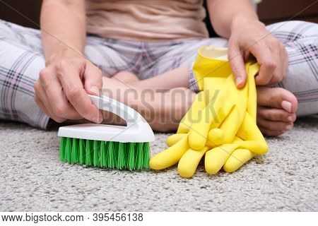 Woman In Yellow Gloves With A Green Brush Is So Tired Of Cleaning And Brushing Carpet, Removing Stai