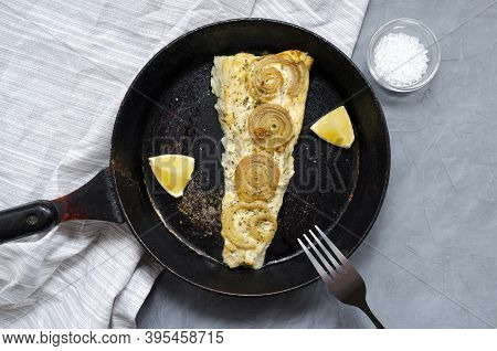 Fried Baked Mackerel Trachurus With Onions And Dried Herbs And Lemon In An Old Pan With A Towel. Wit