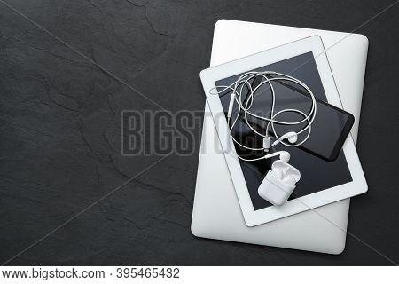 Different Gadgets On Black Stone Table, Top View With Space For Text. Digital Detox Concept