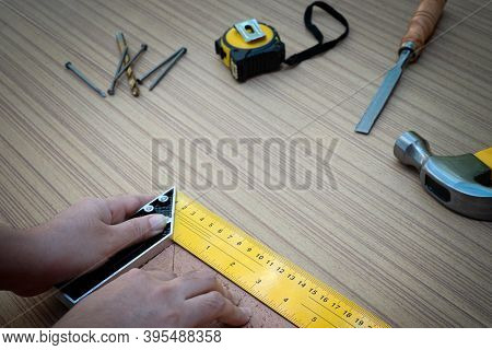 Female Hands Using A Try Square To Check That The Woodworking Corners Are Square With A Set Collecti