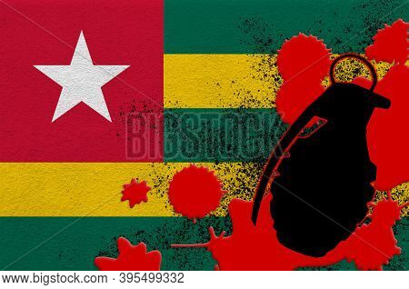Togo Flag And Mk2 Frag Grenade In Red Blood. Concept For Terror Attack Or Military Operations With L