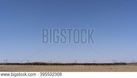 Alakol, Kazakhstan - July 22, 2019: Cargo Train In The Steppe And Desert Of Kazakhstan.
