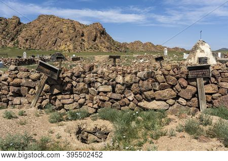 Bayan Olgi, Mongolia, August 5, 2019: Gravestones And Graveyard In The Steppe Of Mongolia With Mount