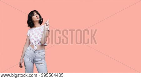 Brunette Woman Is Chewing And Stretching A Gum With Finger Posing In Fashionable Clothes On A Studio