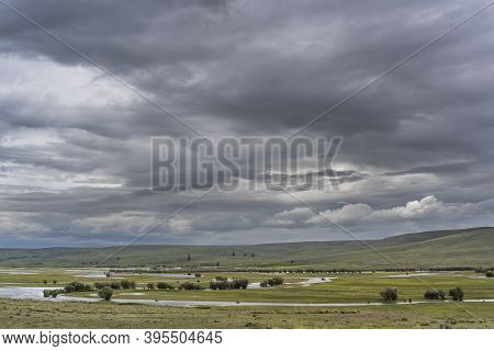 Chuya Valley With Chuya River And Dark Rain Clouds In Altai In Russia.