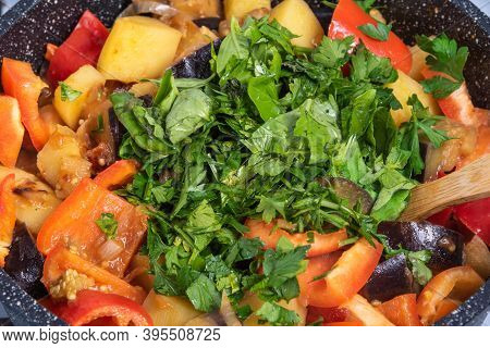 Cooking A Traditional Italian Vegetable Stew With Potatoes, Eggplants And Peppers In A Frying Pan - 