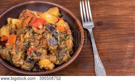 Traditional Italian Vegetable Stew With Potatoes, Eggplants, Tomatoes And Peppers In A Rustic Earthe