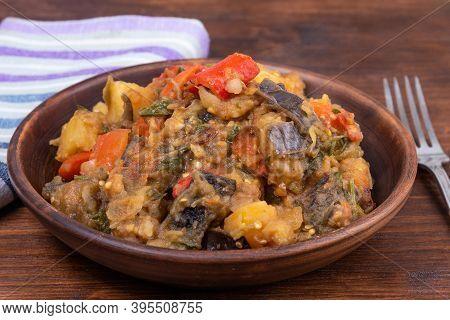 Traditional Italian Vegetable Stew With Potatoes, Eggplants, Tomatoes And Peppers In A Rustic Earthe