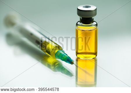 Syringe With Needle & Vial Ampoule With Yellow Liquid,illustration Of Potential Vaccine For Coronavi
