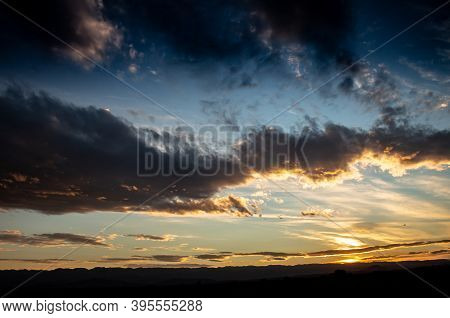 Shocking Sunset Between The Field. Landscape With Distant Mountains During Sunset.