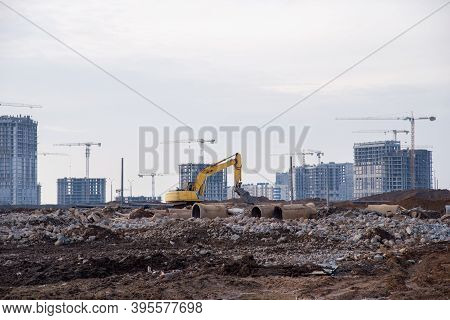 Excavator With Hydraulic Shears Breaks Asphalt And Old Concrete On Construction Site. Hydraulic Shea