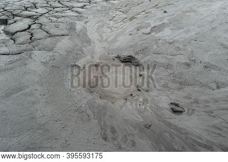 Mud Liquid Flowing From Mud Volcano, At Paclele Mari Mud Volcanoes In Buzau, Romania. Small Volcano-