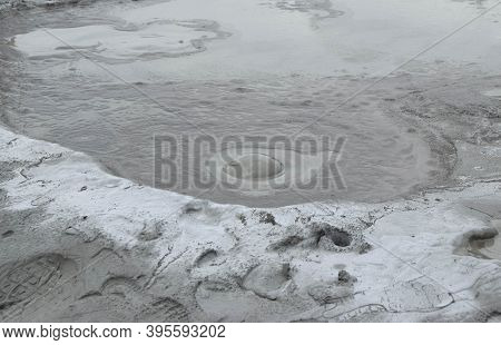 Bubbling Crater Of A Mud Volcano. Close Up View Onto Gas Bubble Exploding In Crater Of Mud Volcano. 