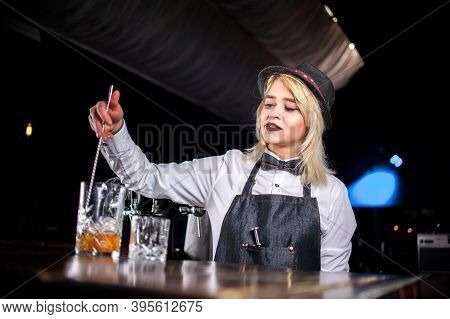 Girl Barman Concocts A Cocktail In The Beerhouse