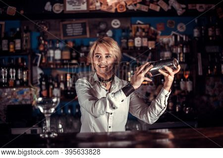 Charismatic Woman Bartender Demonstrates His Professional Skills While Standing Near The Bar Counter