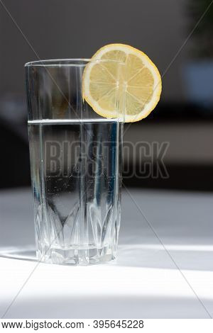 Glass Of Water With Lemon On A Table