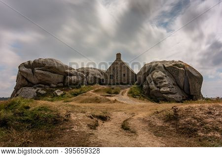 House Between Rocks In Meneham On The Atlantic Coast In Northern Brittany (france), Cloudy Day In Su