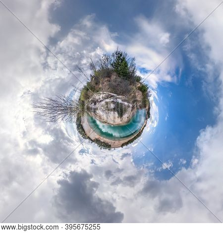 Green Tiny Planet In Blue Sky With Beautiful Clouds. Transformation Of Spherical Panorama 360 Degree