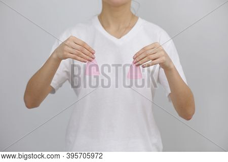 Close Up Of Woman Holding Pink Menstrual Cups Of Different Size In Her Hands On White Background. Gy