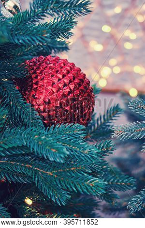Red Ribbed Ball As A Decoration For The New Years Celebration, Golden Bokeh. Winter Christmas Tree I