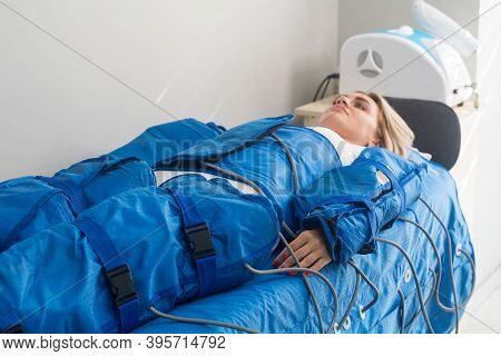 Pressotherapy Machine On Woman In Beauty Clinic. Cosmetic Medicine Procedure. Hardware Cosmetology