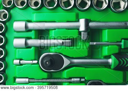 Mechanics Tool Set And Mechanic's Tool Box Close-up. Plastic Green Storage Box Case. Mechanics Tool