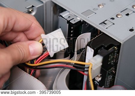 Hands Of A Technician Pluging The Cable While Computer Rapair And Fixing