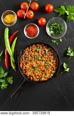 Keema Curry In Frying Pan Over Black Stone Background. Indian And Pakistani Style Dish. Top View, Fl