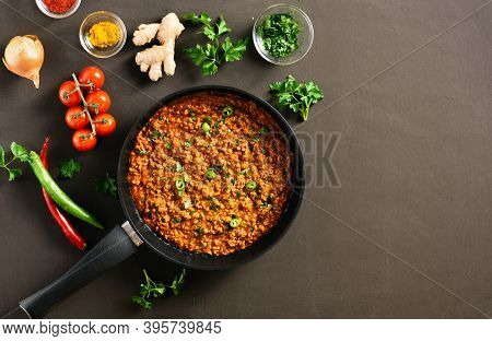 Keema Curry In Frying Pan Over Brown Background With Copy Space. Indian And Pakistani Style Dish. To