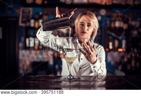 Charming Woman Bartending Mixes A Cocktail At The Bar Counter