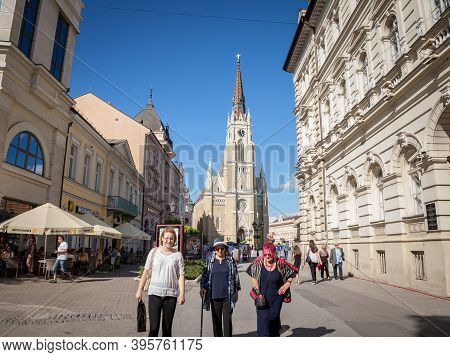 Novi Sad, Serbia - June 11, 2011: Senior Old Women Walking By The Name Of Mary Church, Or Novi Sad C