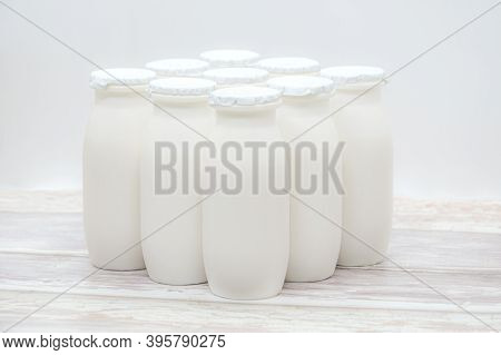 Natural Liquid Yogurt With Probiotics In Small Plastic Bottles On Wooden Table. Healthy, Balanced Di