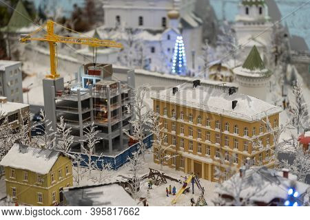 Miniature Construction Of A High-rise Building With A Tower Crane.