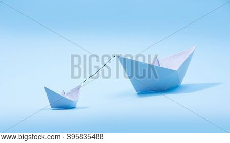 Paper Boats - Tugboat Or Remorker Pulling A Big Boat On Blue Background. Little Helper Concept, Tugb
