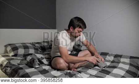 Young Man Measuring Blood Pressure At Home. Hypertensive Patient Performing An Automatic Blood Press