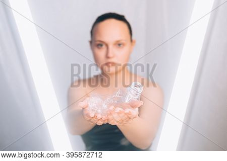 Plastic Pollution. Waste Recycling. Nature Conservation. Futurustic Portrait. Used Creased Bottle In
