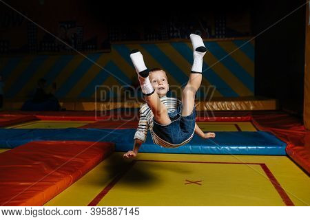 Clumsy Little Boy Jumping On A Square Trampoline In Entertainment Center