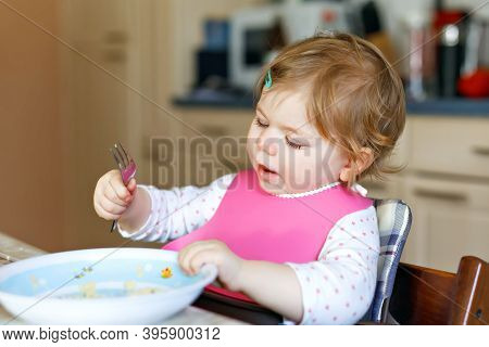 Adorable Baby Girl Eating From Spoon Mashed Vegetables And Puree. Food, Child, Feeding And People Co