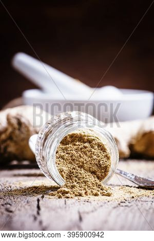 Ground Ginger In A Glass Jar And Fresh Ginger Root, Vintage Wooden Background, Selective Focus
