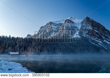Lake Louise In Early Winter Sunny Day Morning. Mist Floating On Turquoise Color Water Surface. Clear