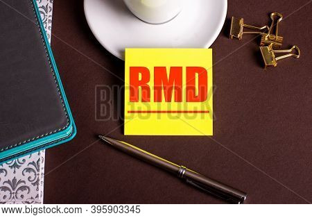 Rmd Written On Yellow Paper On A Brown Background Near A Coffee Cup And Diaries