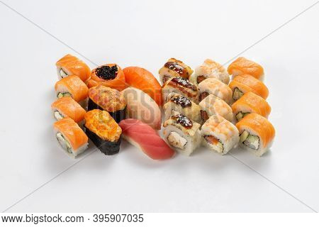 Set Of Different Types Of Sushi Maki, Nigiri And Gunkans On A Neutral Light Background