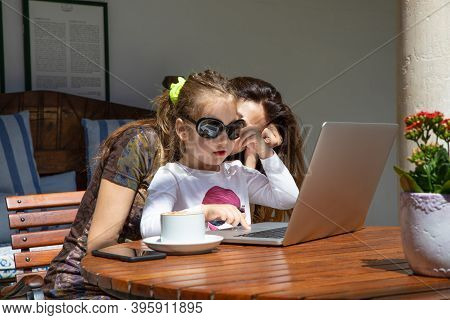 Little Girl Surfing On Laptop Trackpad With Woman